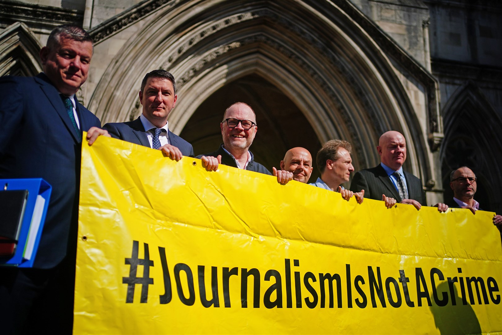 Barry McCaffrey, centre, and Trevor Birney, third left, with lawyers and supporters outside the Royal Courts of Justice in London (Victoria Jones/PA).