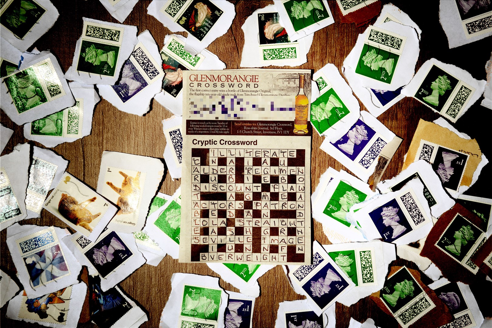 A completed crossword entry surrounded by some of the stamps we have collected to date. Picture: James Mackenzie.