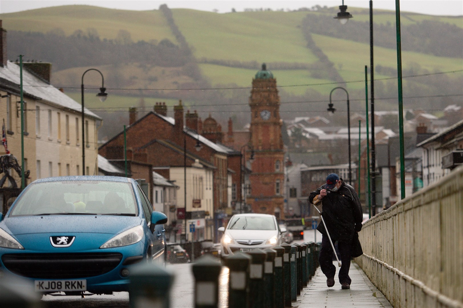 A man wearing a face covering in Newtown, in the county of Powys, Mid Wales (Jacob King/PA)