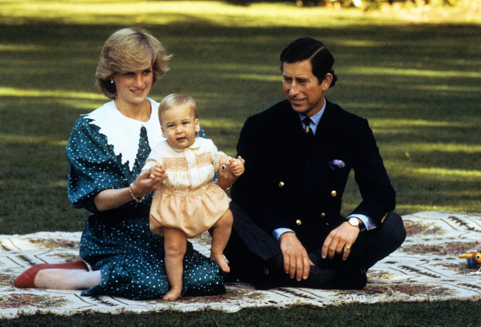 The Prince and Princess of Wales amuse baby Prince William in the grounds of Government House in Auckland, New Zealand in 1983 (PA)