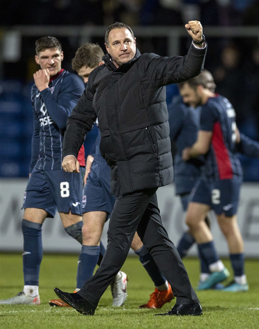 Ross County manager Malky Mackay celebrates to home fans at the end.