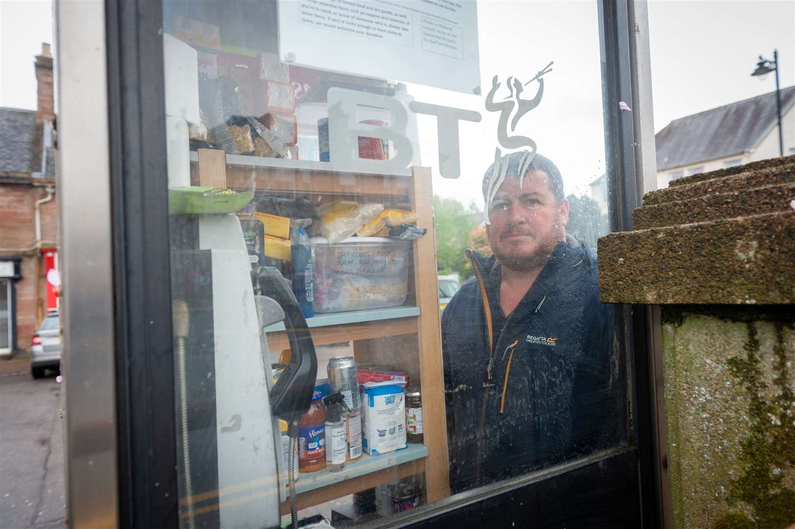 Roy Harrison with the phone box in Beauly Square which has become a community larder.