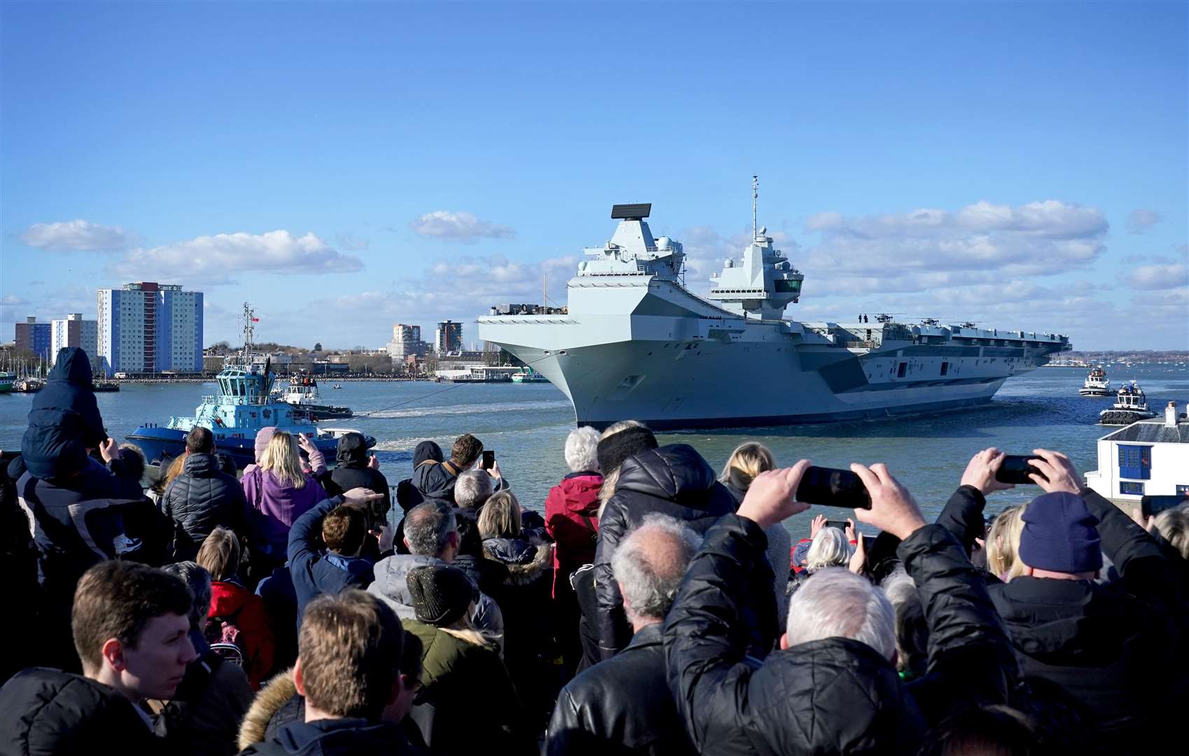 Crowds watch as the Royal Navy aircraft carrier HMS Prince of Wales sets sail from Portsmouth Harbour on Monday (Gareth Fuller/PA)
