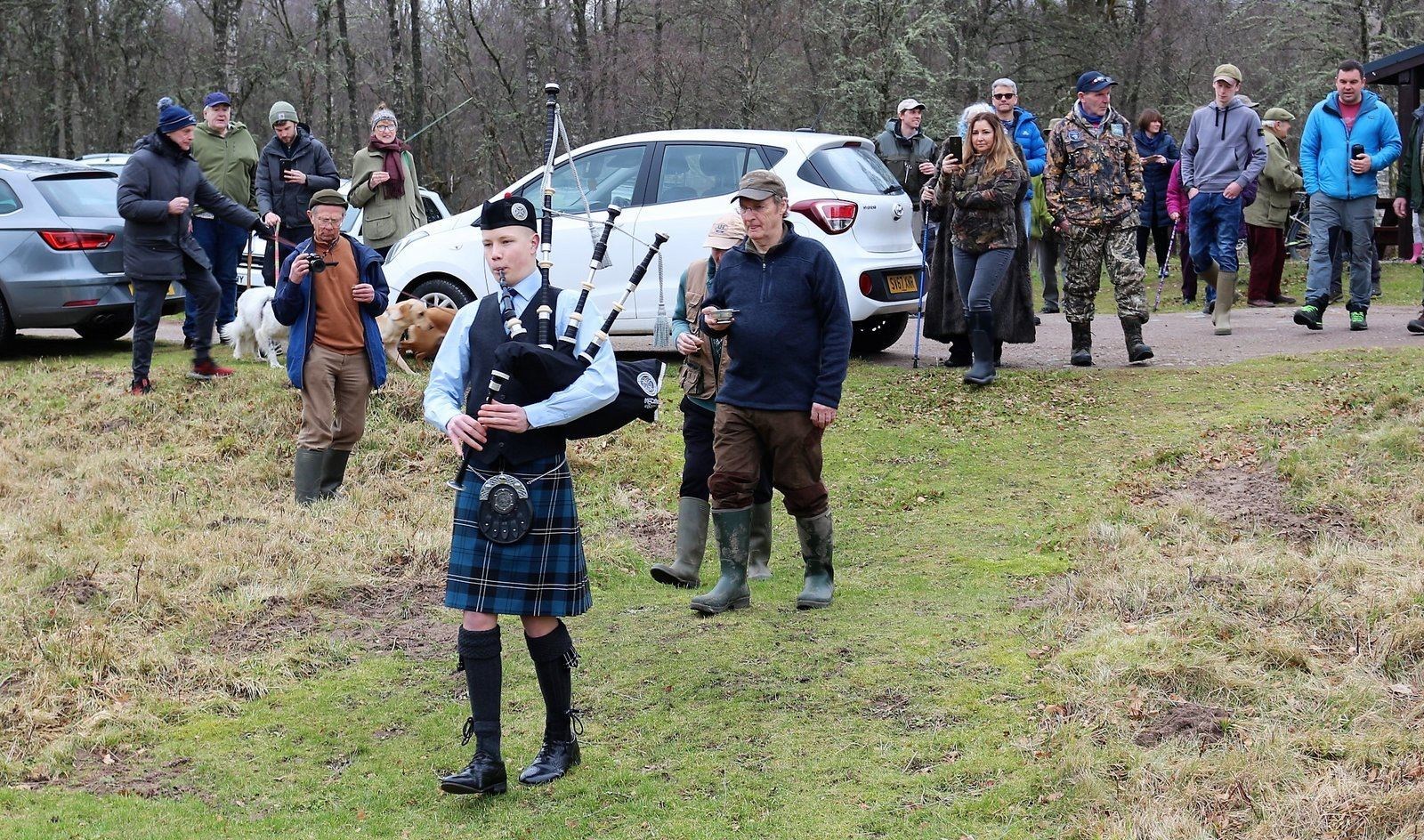 Piper Liam Bolger leads the gathering to the river.