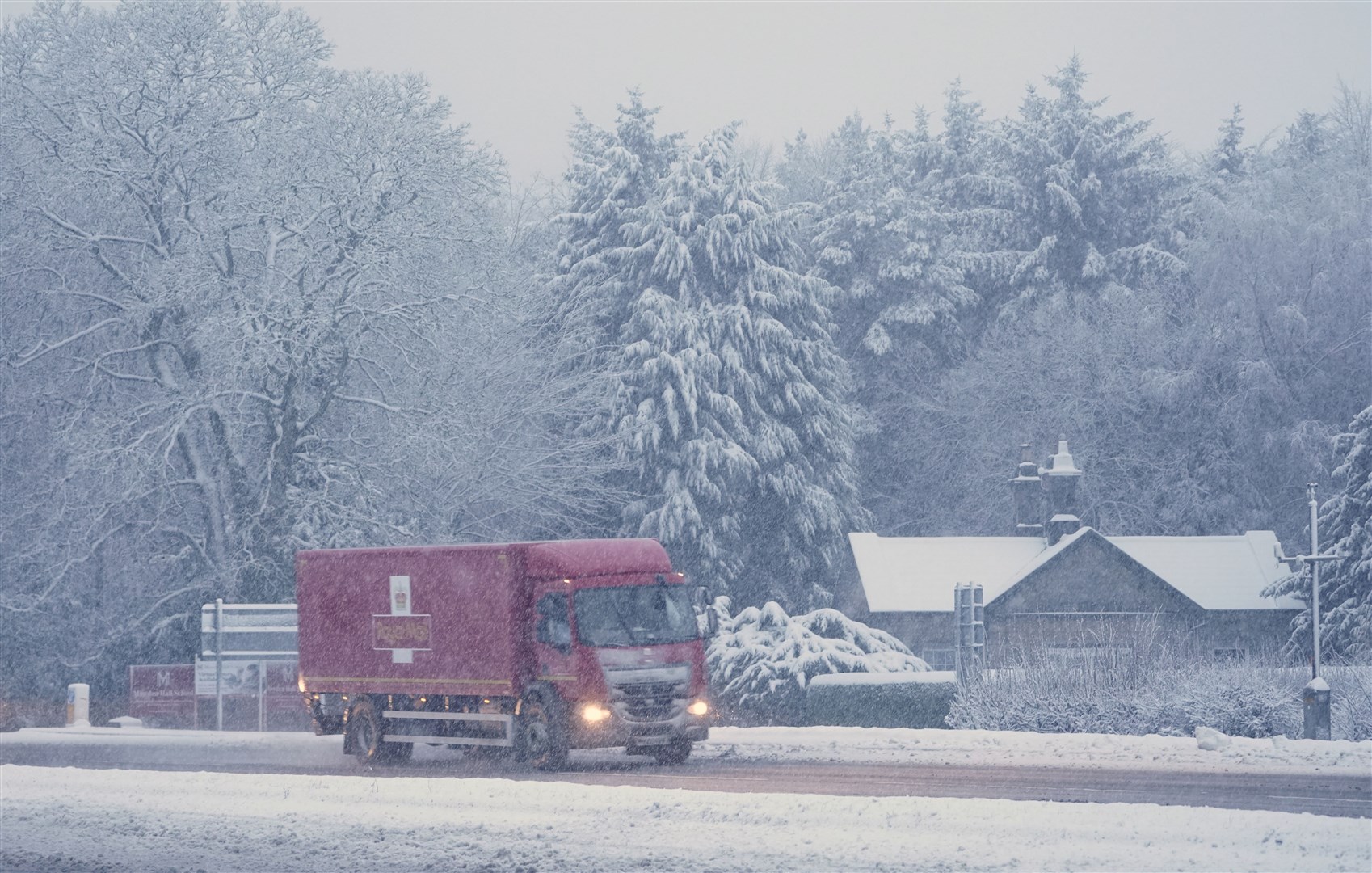 A Royal Mail lorry drives through snow on the A69 near Newcastle (Owen Humphreys/PA)