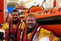 RNLI crew members celebrate after passing helm assessments