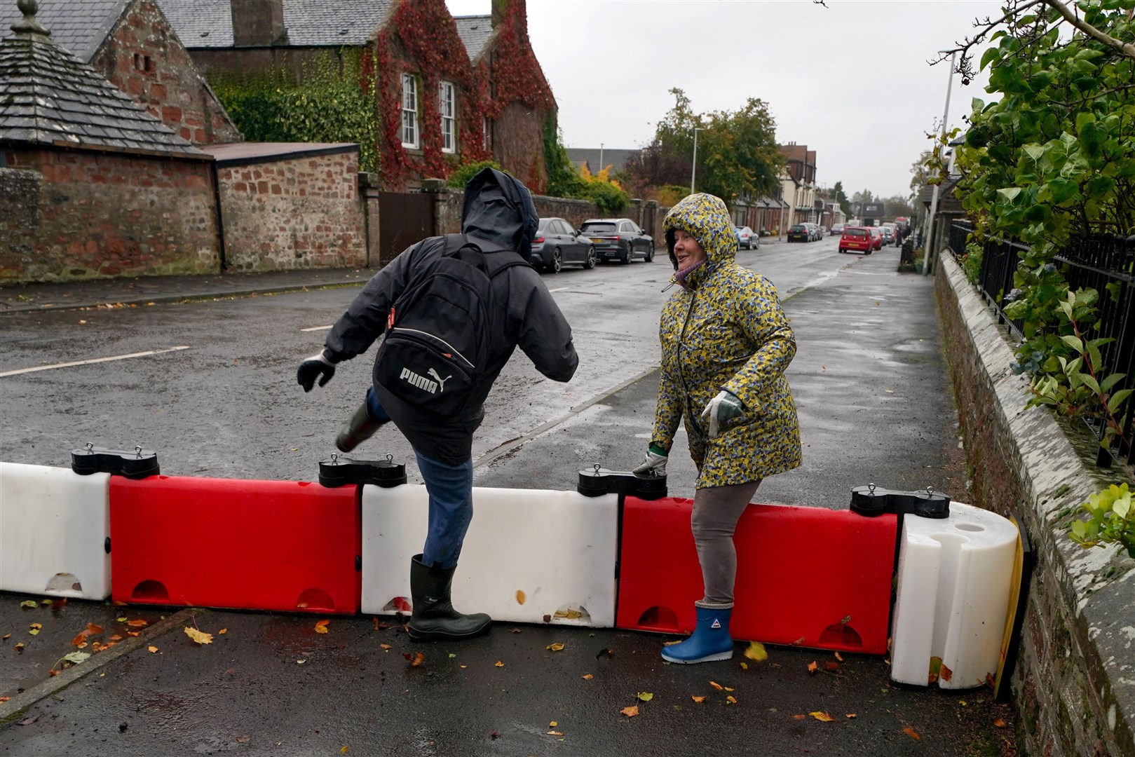 Flood defence barriers were erected in towns and villages across Scotland where a red warning has been issued (Andrew Milligan/PA)