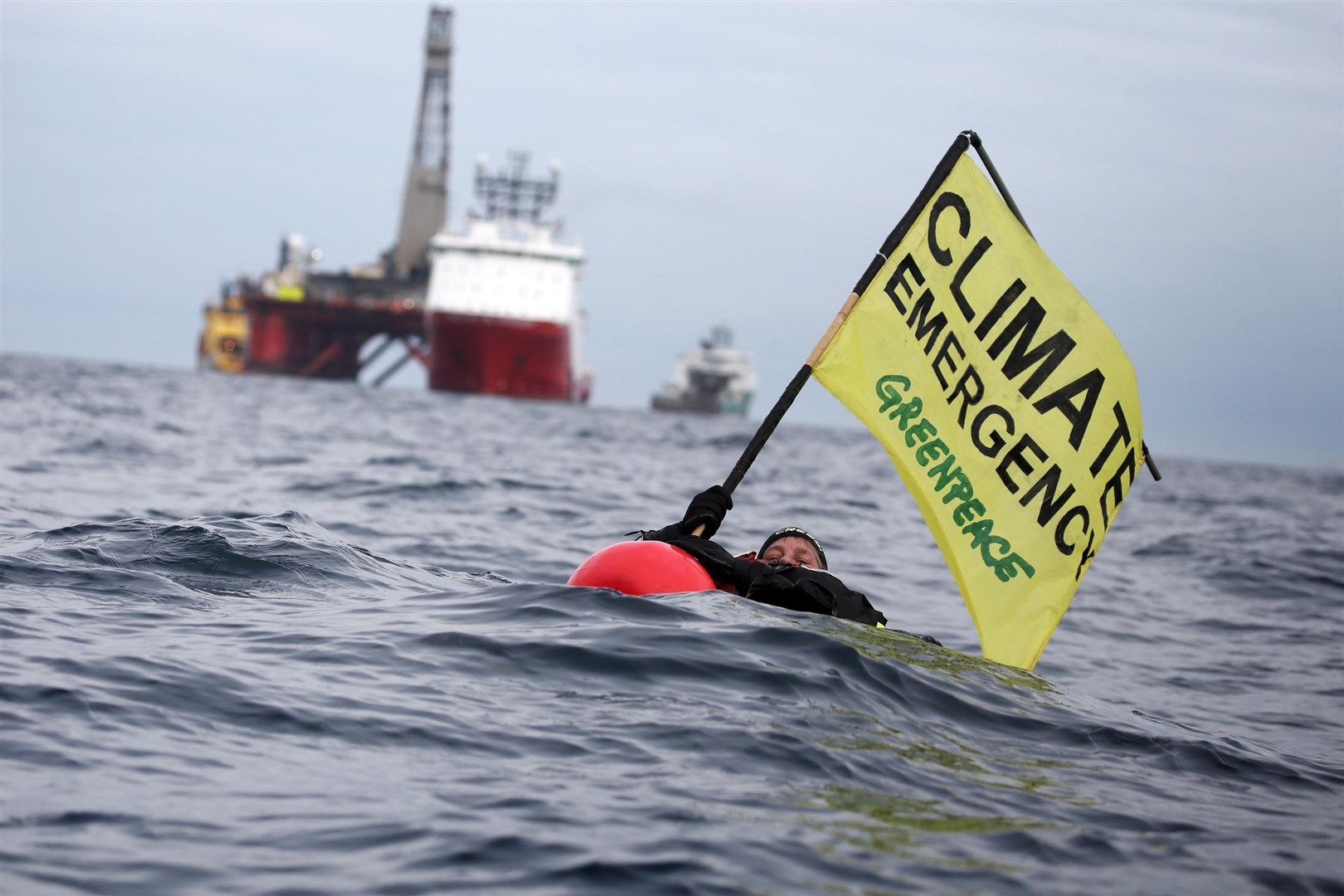 Greenpeace campaigner Sarah North holds a banner whilst floating in front of BP rig before the protest in the North Sea was brought to a conclusion. Picture: Greenpeace