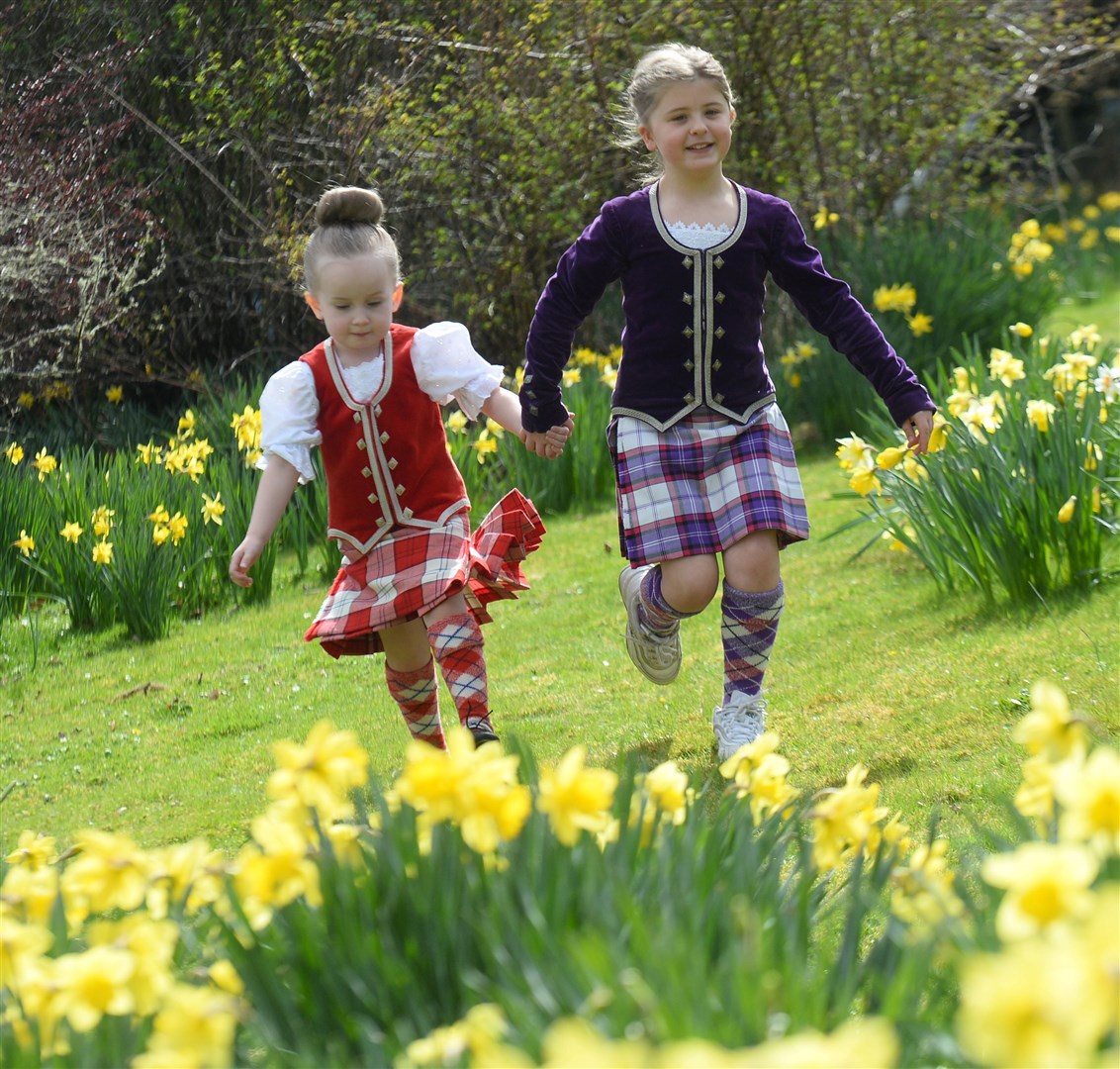 Penny Calder and Gracie Schofield skip through the daffodils. Picture Gary Anthony