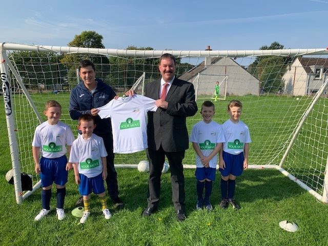 Nigel Cheal, centre, and Adam Wilsher, the head coach of North Kessock Primary FC, with the sponsored kit.
