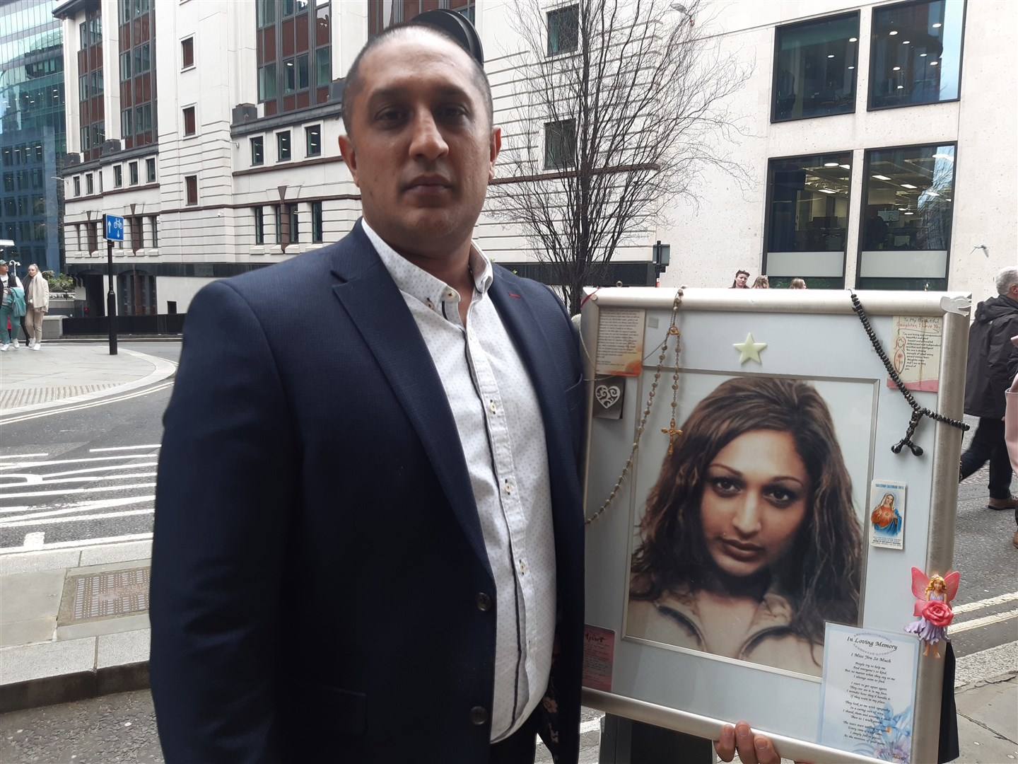 Portrait of Sabina Rizvi held by her brother Zshan Rizvi outside the Old Bailey (Helen William/PA)