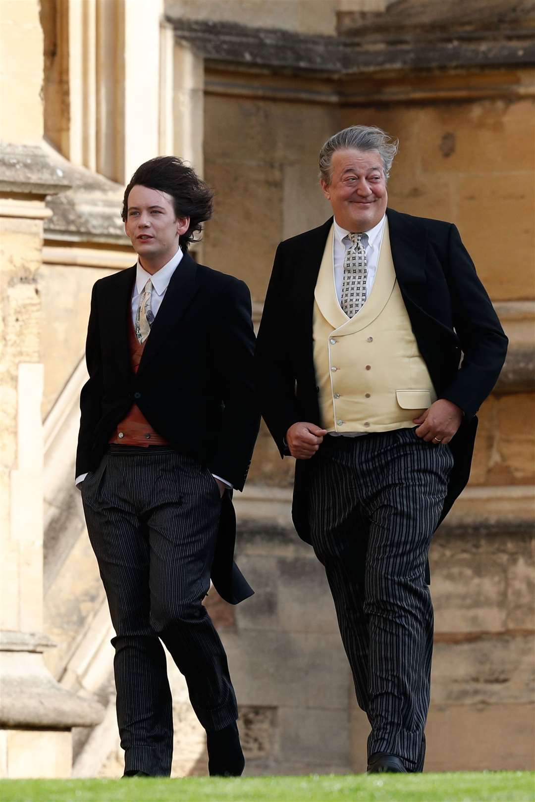 Stephen Fry and husband Elliott Spencer arrive to attend the wedding for the wedding of Princess Eugenie to Jack Brooksbank at St George’s Chapel in Windsor Castle (Adrian Dennis/PA)