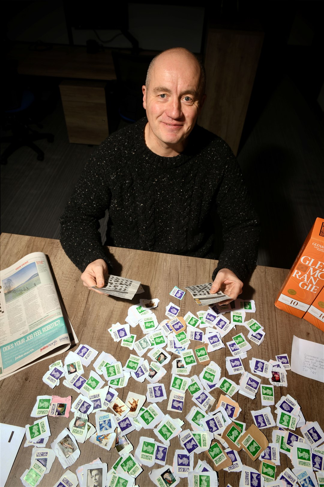 Hector Mackenzie, the Ross-Shire Journal’s content editor, with some of the stamps from our Glenmorangie-sponsored crossword. These will benefit the RNIB charity. Picture: James Mackenzie