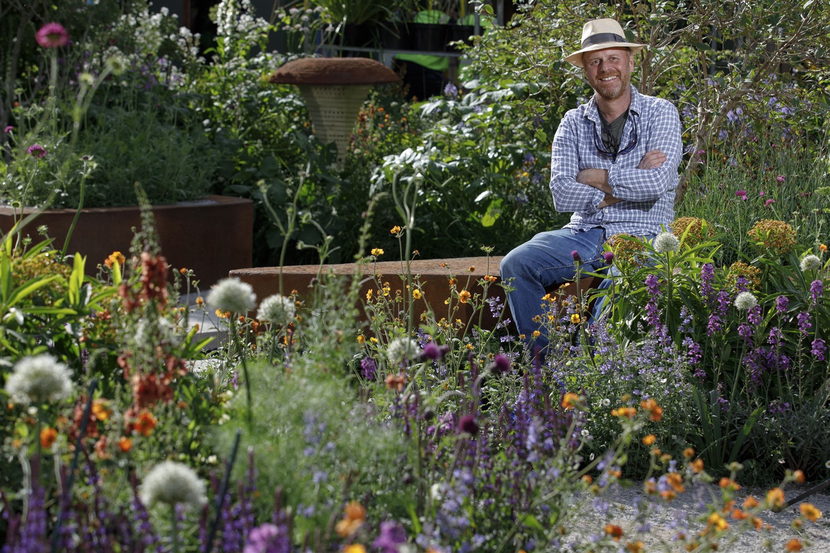Garden designer Joe Swift in the BBC Studios Our Green Planet and RHS Bee Garden he designed, a space filled with plants for pollinators (Luke MacGregor/RHS/PA)