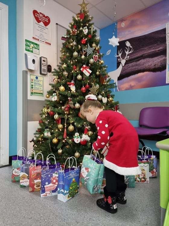 Maisie Star Torley hands over gifts at Highland Children's Unit at Raigmore Hospital.