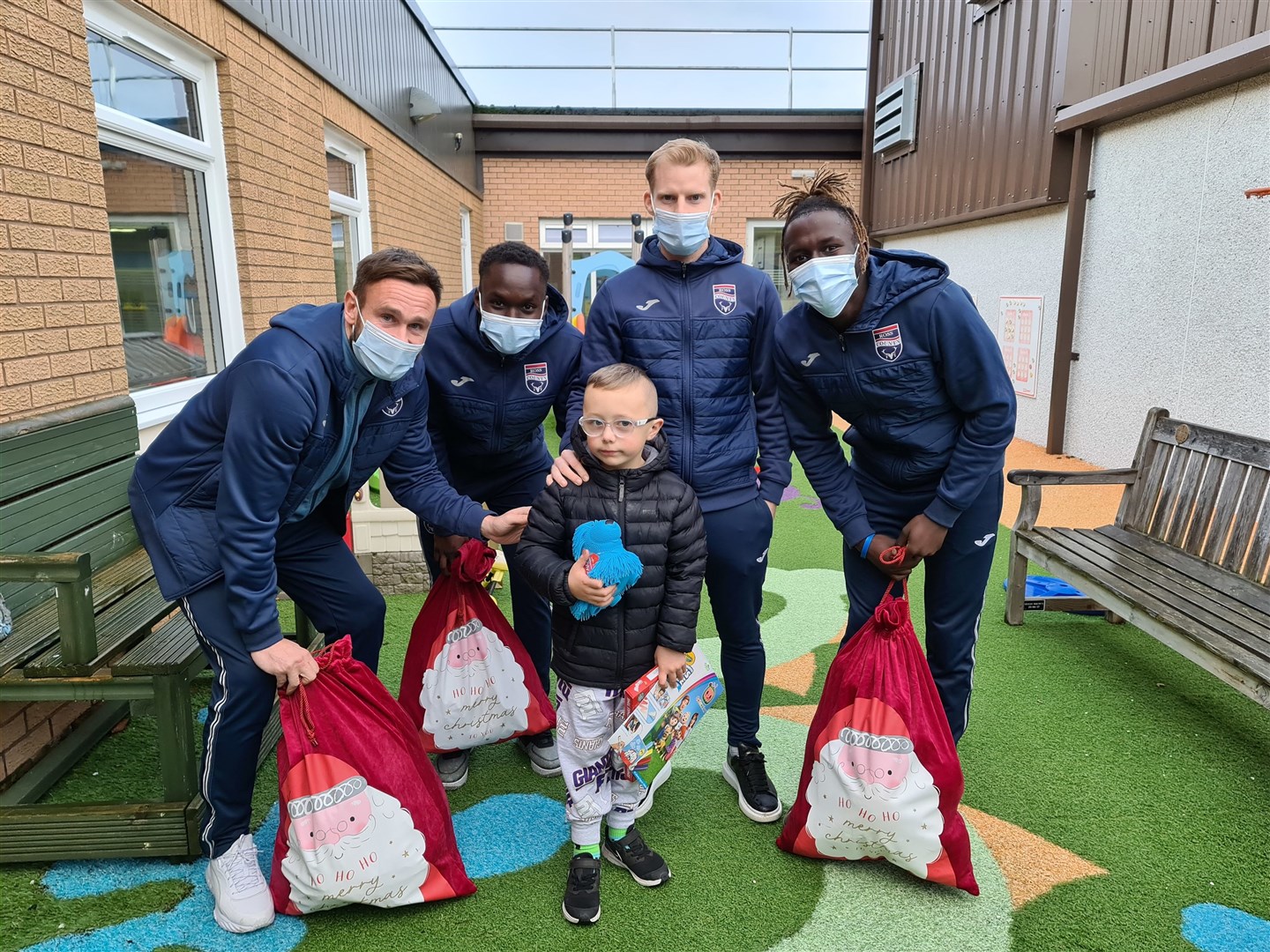 Ross County players with young patient Dawson Duffus (7) at the Highland Children's Unit at Raigmore Hospital.