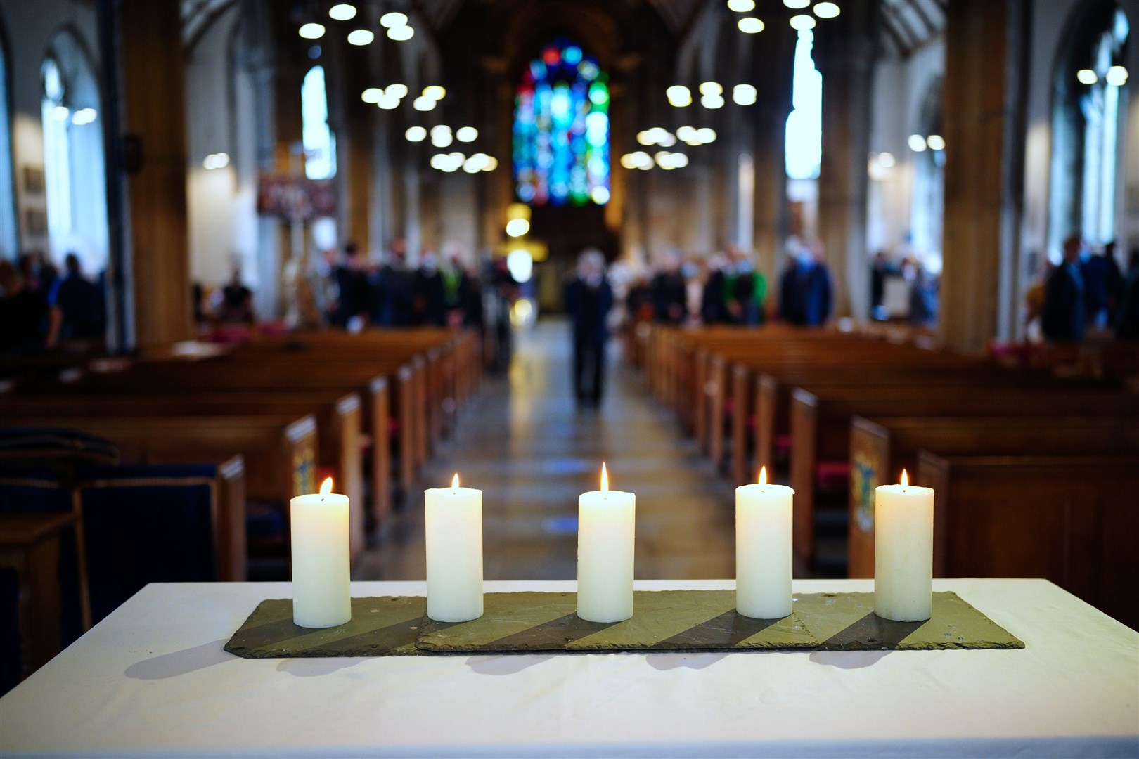 Five lit candles on the altar following a civic service led by the Bishop of Plymouth at Minister Church Of St Andrew, to remember the five people who were killed by gunman Jake Davison (Ben Birchall/PA)