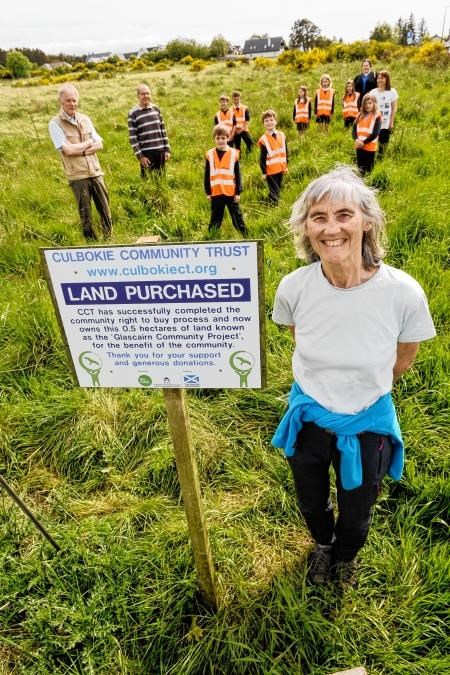 Culbokie Community Trust's Penny Edwards (front) is pictured at the community-owned land with trust directors Ian MacIver (left), Bruce Morrison and Carol Elliot (right) after a previous milestone. Also pictured is senior playworker Laura Maclennan with the children of Culbokie.