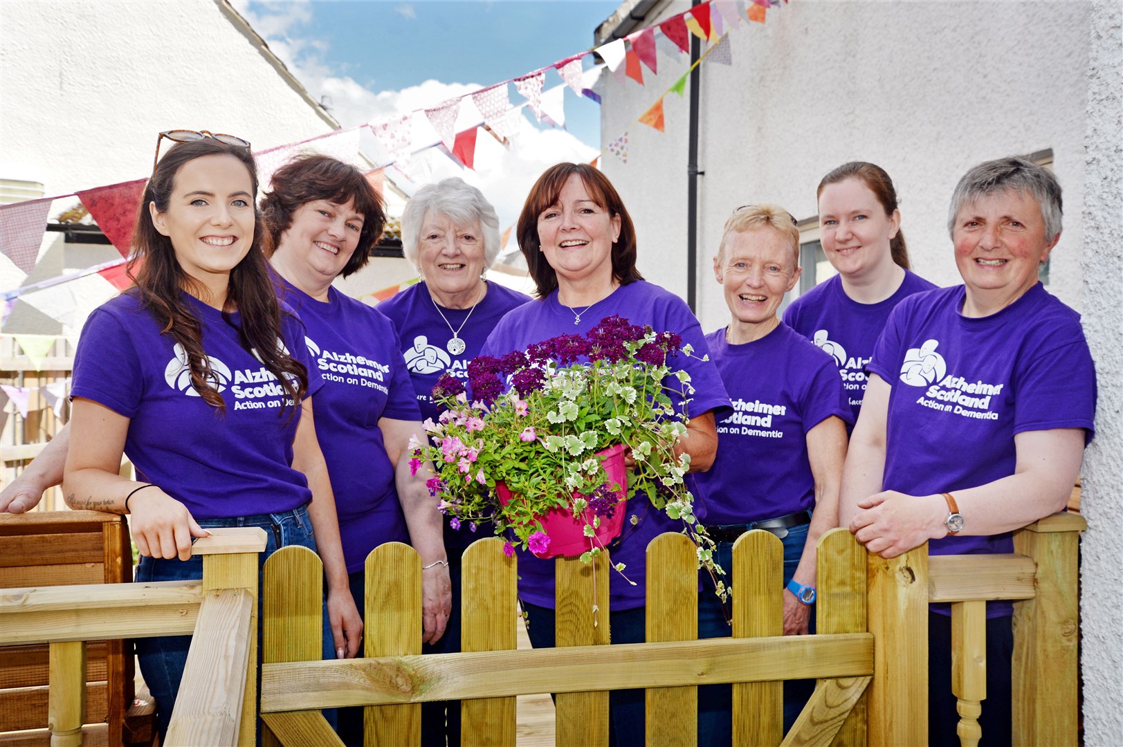 Gail Goller (centre), locality leader of Alzheimer Scotland, with staff and volunteers who helped run the garden party at the Dingwall Dementia Resource Centre. Picture: Gair Fraser. Image No. 044121