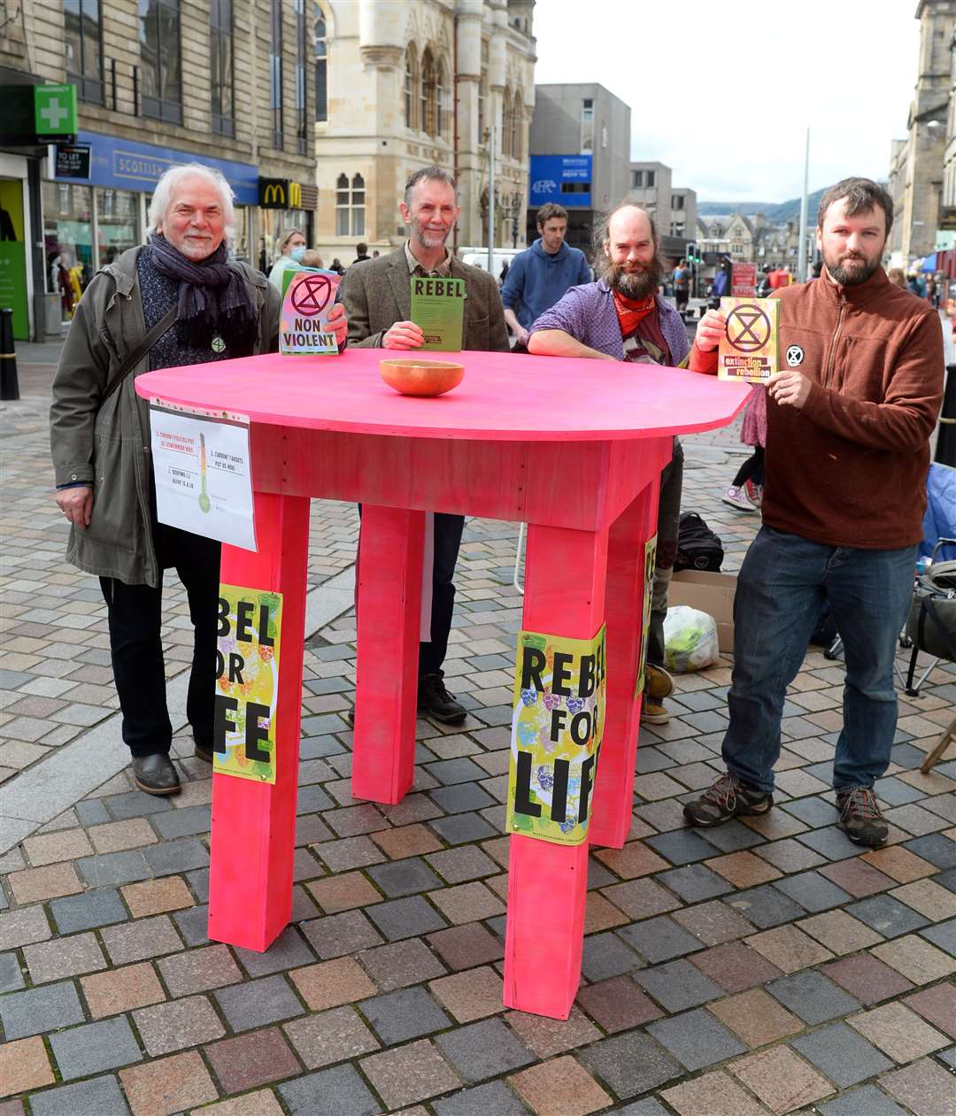 EXR members Dominic Thierry, Simon MacLardie, Adam Pellant and Finlay Ross invite passersby to come to big table. Picture: Gary Anthony