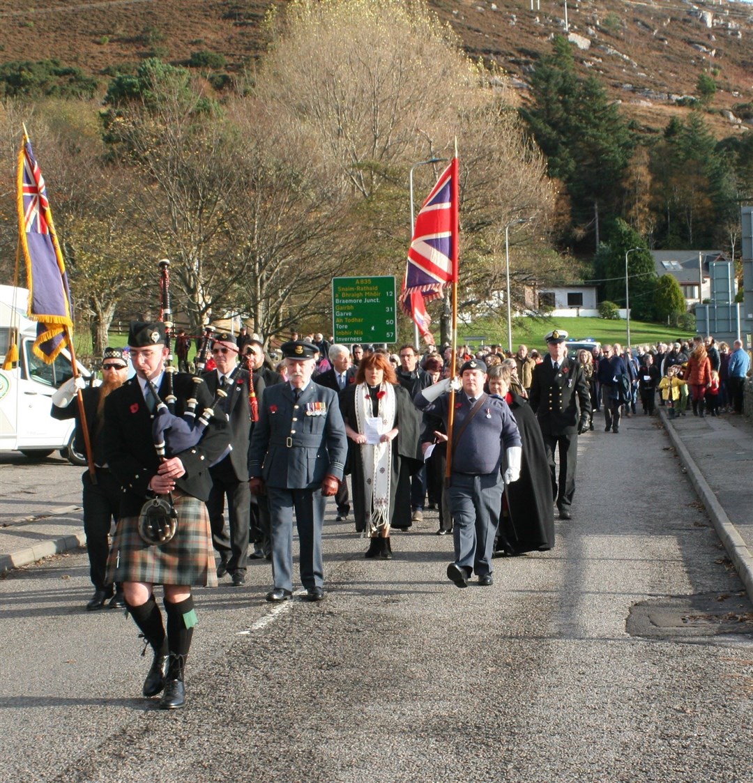 Procession through Ullapool, piped by Hardie Crawford.