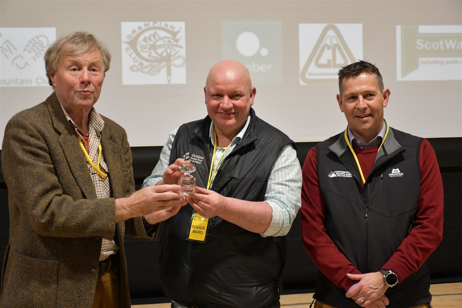 Scottish Mountain Trust chairman John Fowler (left) presents OATS chief exec Dougie Baird and Scottish Mountaineering CEO Stuart Younie (right) with the £100,000 Diamond Grant at the Dundee Mountain Film Festival.