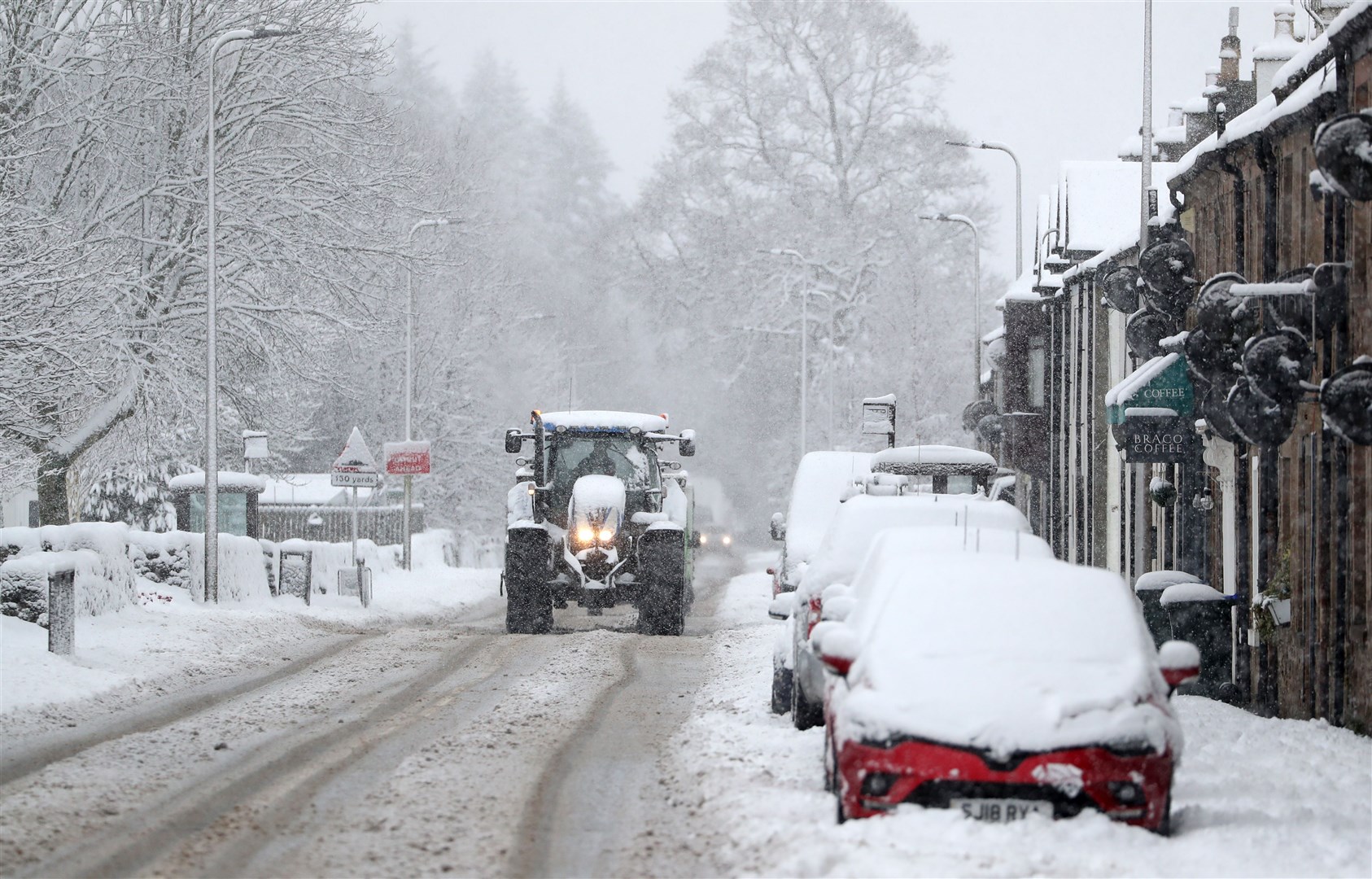 A tractor makes its way through snow in Braco, near Dunblane, in Scotland (Andrew Milligan/PA)