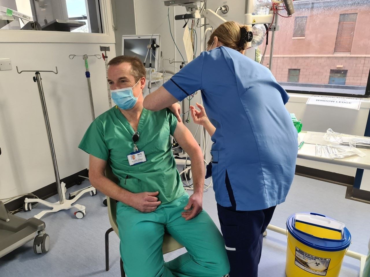 Dr Jonathan Whiteside, Clinical Lead for Critical Care with NHS Highland, is the firstperson to be vaccinated within the NHS Highland area. Maureen Sutherland is administering the vaccine.