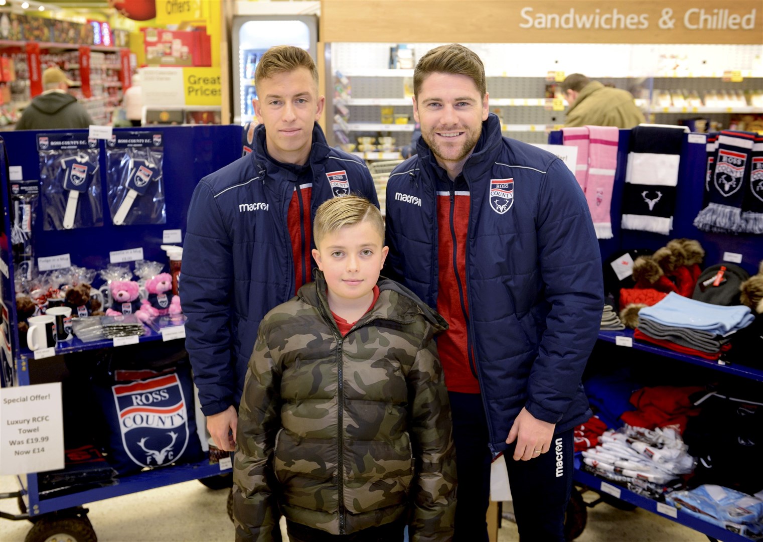 Harry Paton and Iain Vigurs with Aaron Chalmers, a Ross County supporter Picture: James MacKenzie