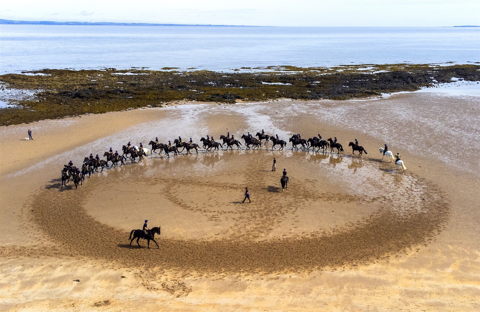Members of the Household Cavalry, Blues and Royals, exercise their horses at Yellowcraig Beach (Jane Barlow/PA)