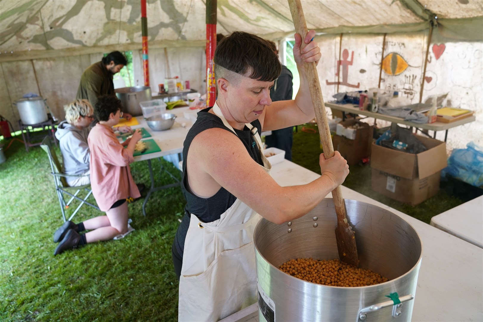 An activist gets to work cooking for the camp which will be in place over the weekend (Andrew Milligan/PA)