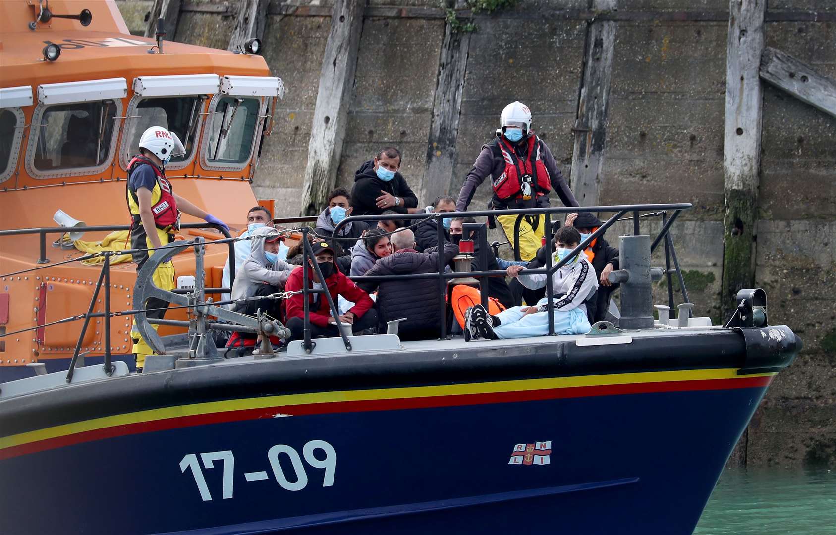 A group of people, suspected to be migrants, are brought into Dover by an RNLI lifeboat (Gareth Fuller/PA)