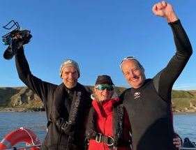 James Fletcher (right) with his wife Kate and Mark Georgeson, who provided support during the paddleboard crossing.