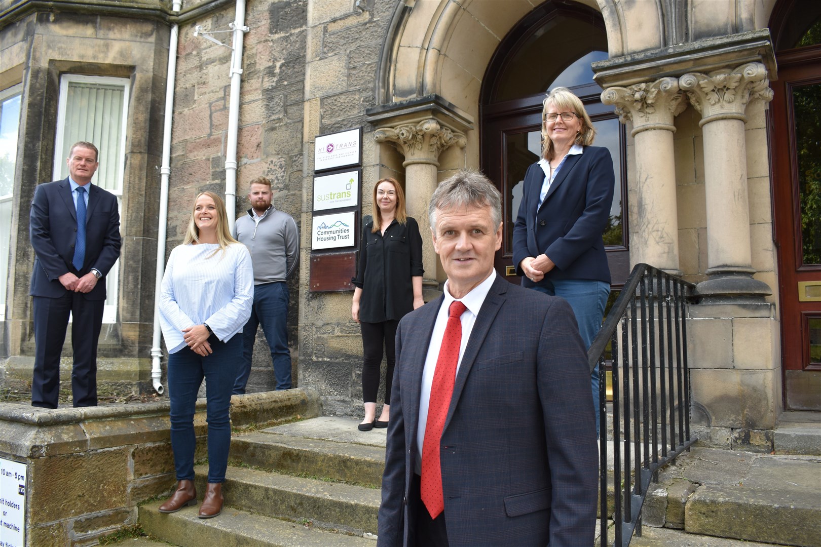 Chief executive Ronnie Macrae and other members of the CHT team outside their Inverness headquarters.