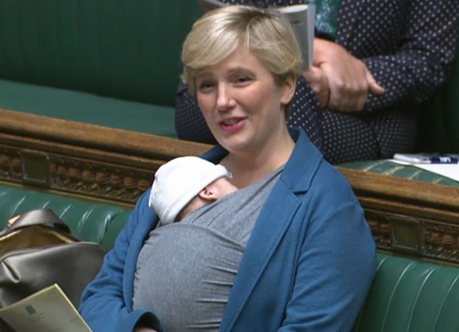 Labour MP Stella Creasy speaking in the chamber of the House of Commons, in London, with her newborn baby strapped to her (House of Commons/PA)