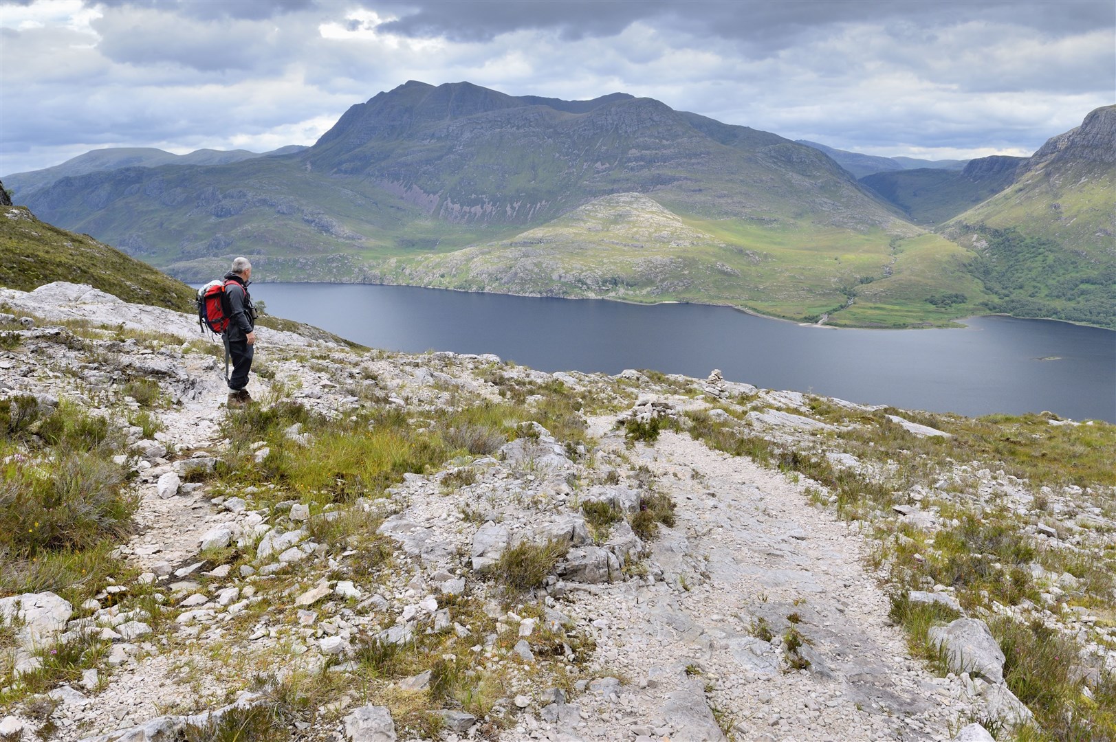 A hillwalker enjoying the view over Loch Maree from the mountain trail at Beinn Eighe National Nature Reserve, Wester Ross. August 2015. ©Lorme Gill/SNH.