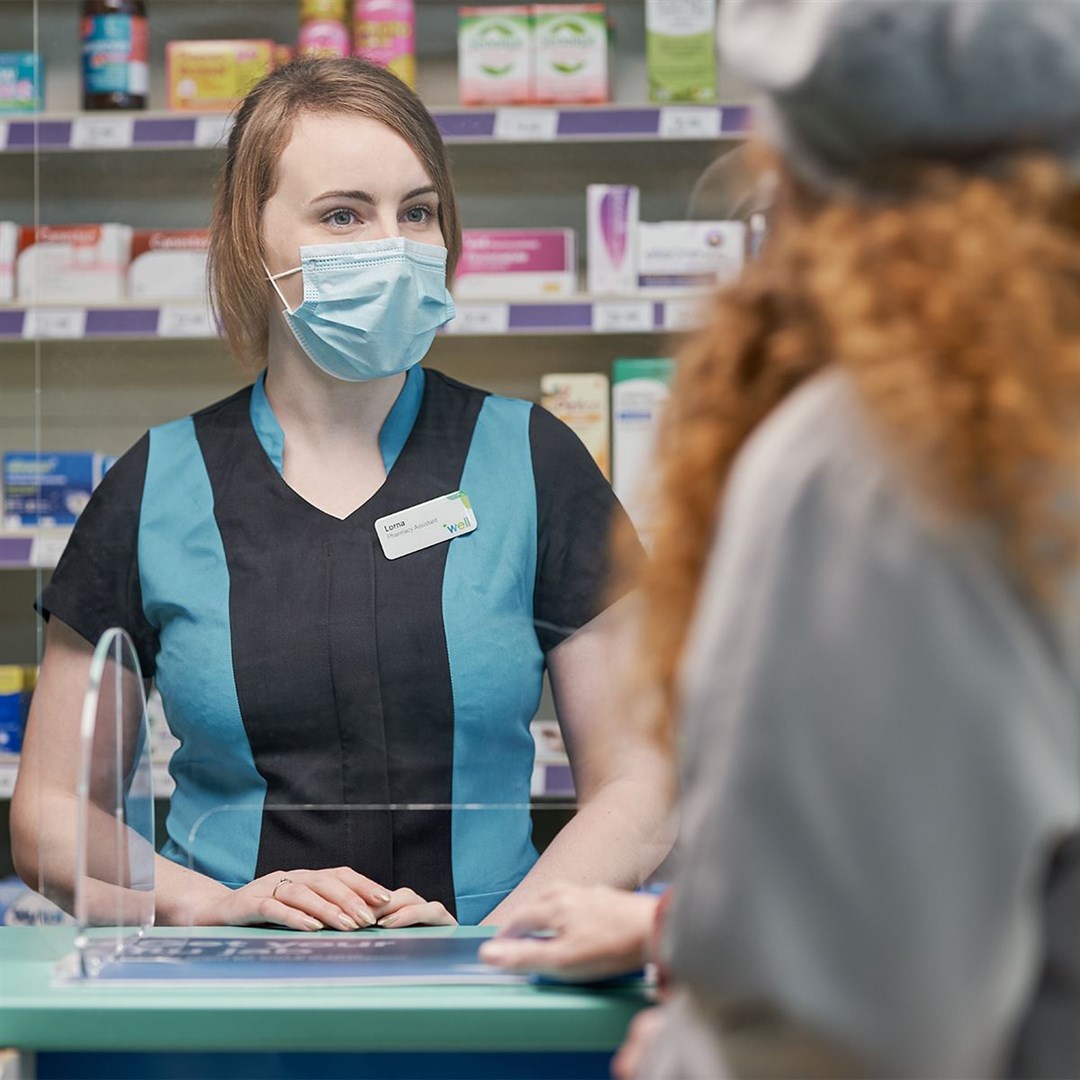 A pharmacist helps a customer.