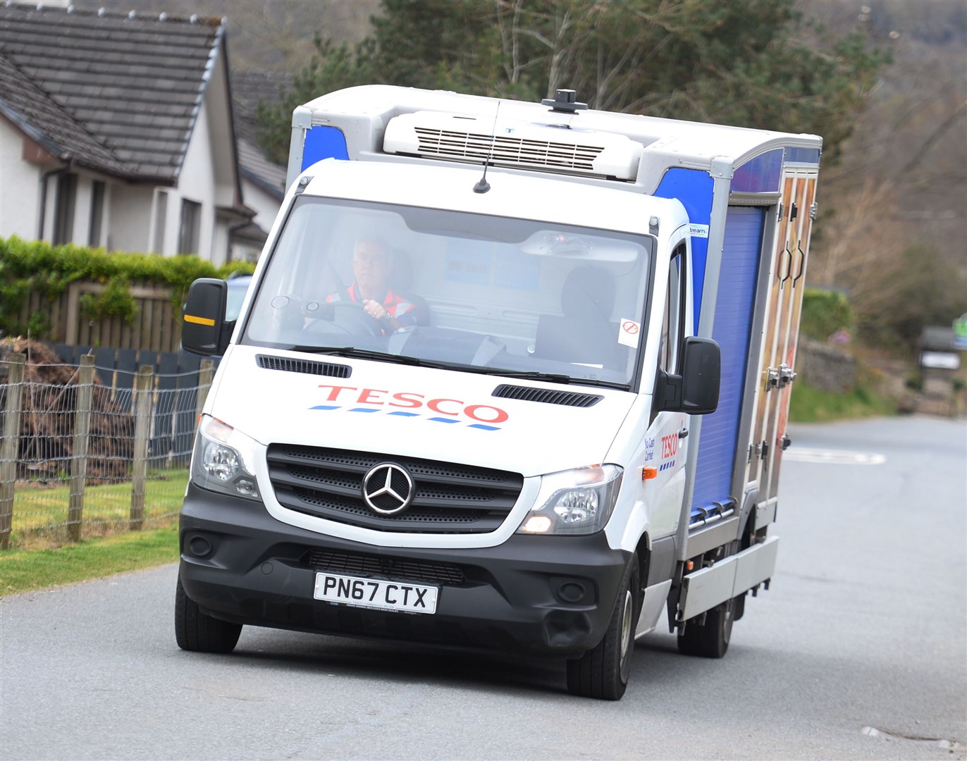 A Tesco delivery van does the rounds.