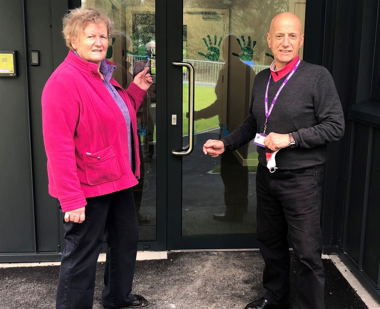 Vice Convener Cllr Isabelle (Biz) Campbell and Education Chair Cllr John Finlayson stand outside the new building