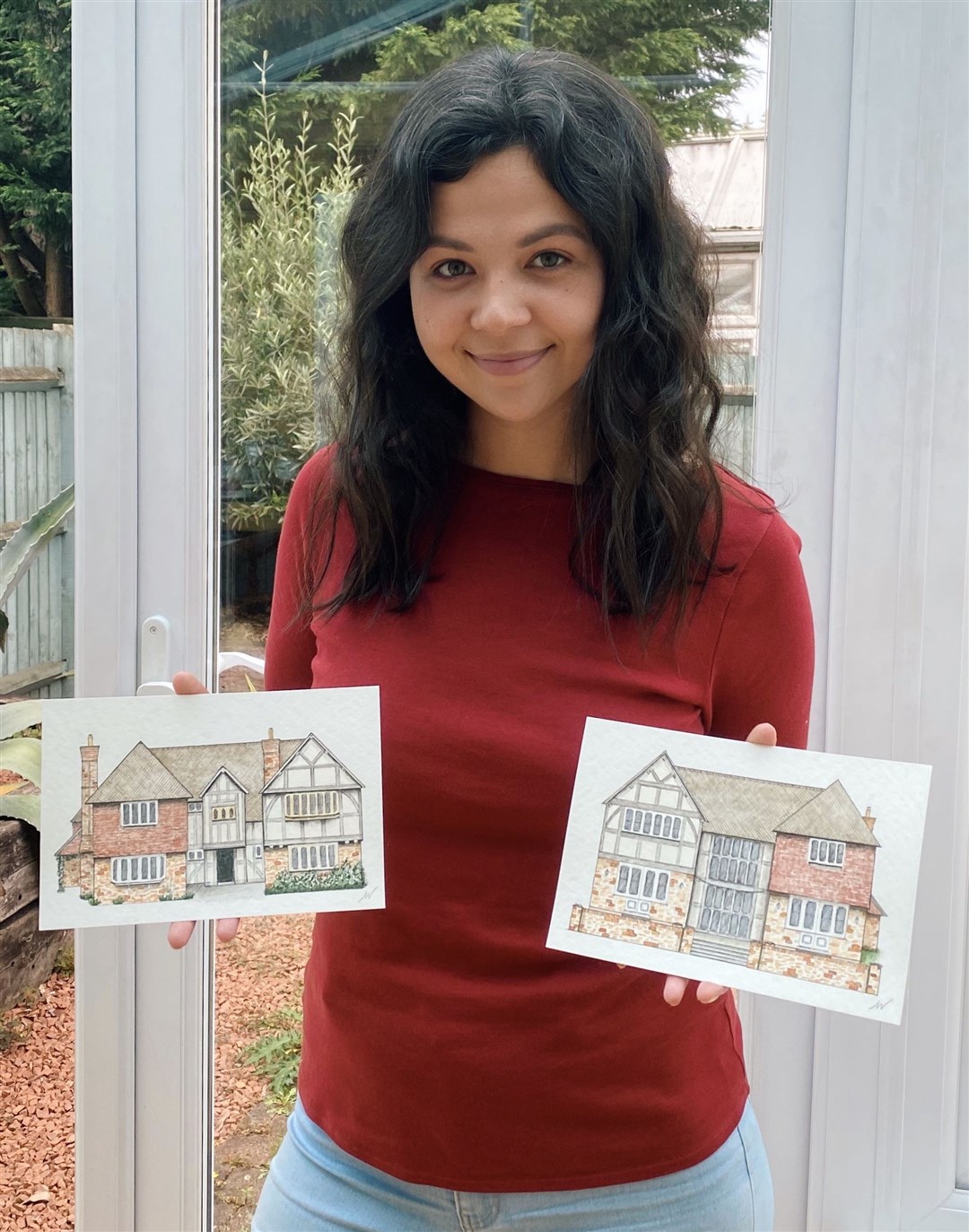 Young artist Matilda Walker from Fortrose with two of her recently-commissioned 'house portraits'