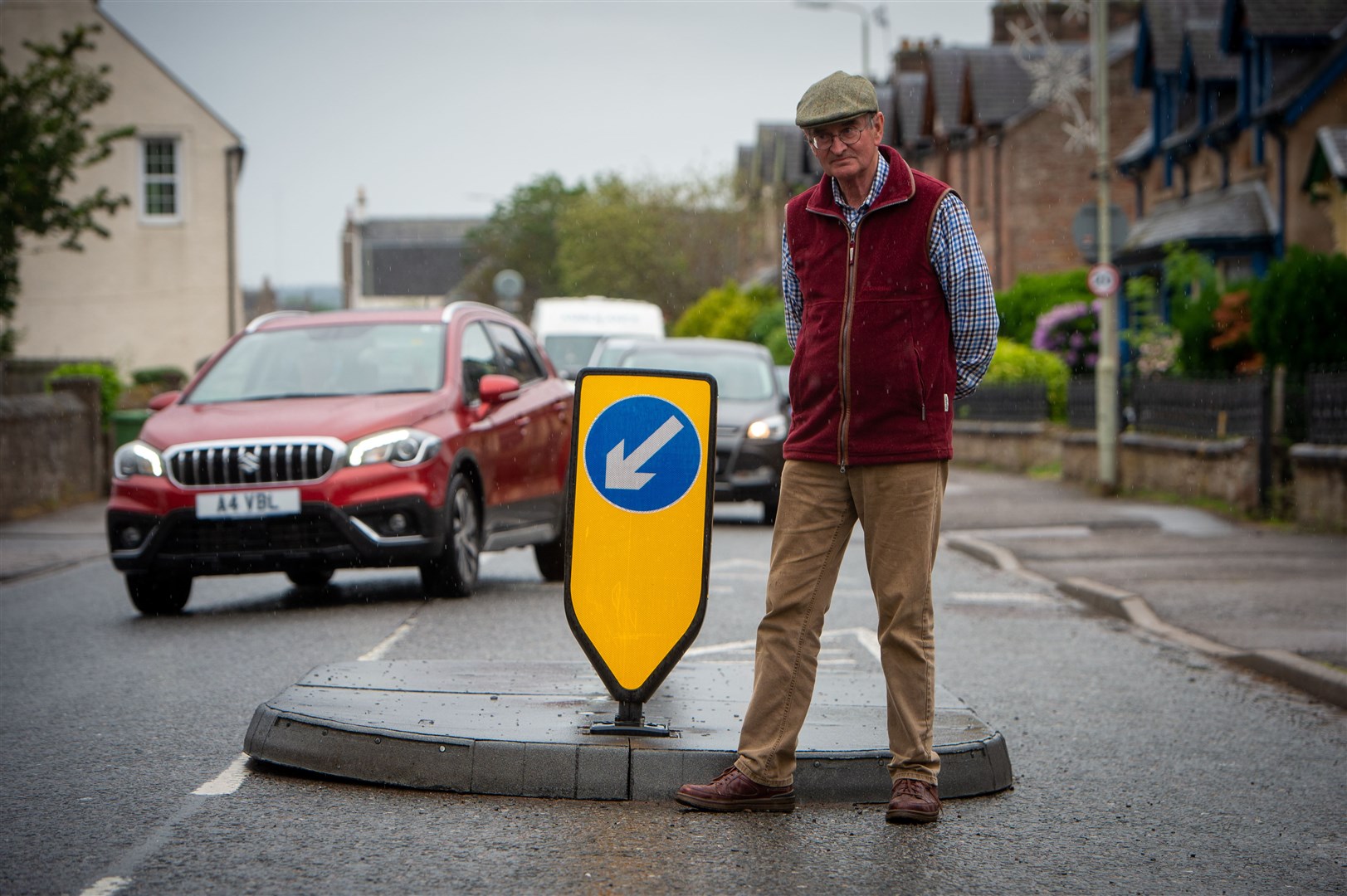 David Lockett at a traffic island outside the police station Dingwall. As well as pushing for action on a new link road to ease congestion and open up development, community activists in Dingwall have questions about the efficacy of temporary traffic calming measures. Picture: Callum Mackay