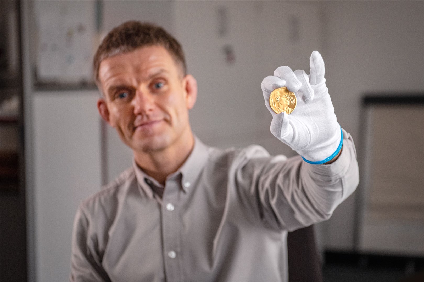 Thomas Docherty with the 40th birthday coin (Royal Mint/PA)