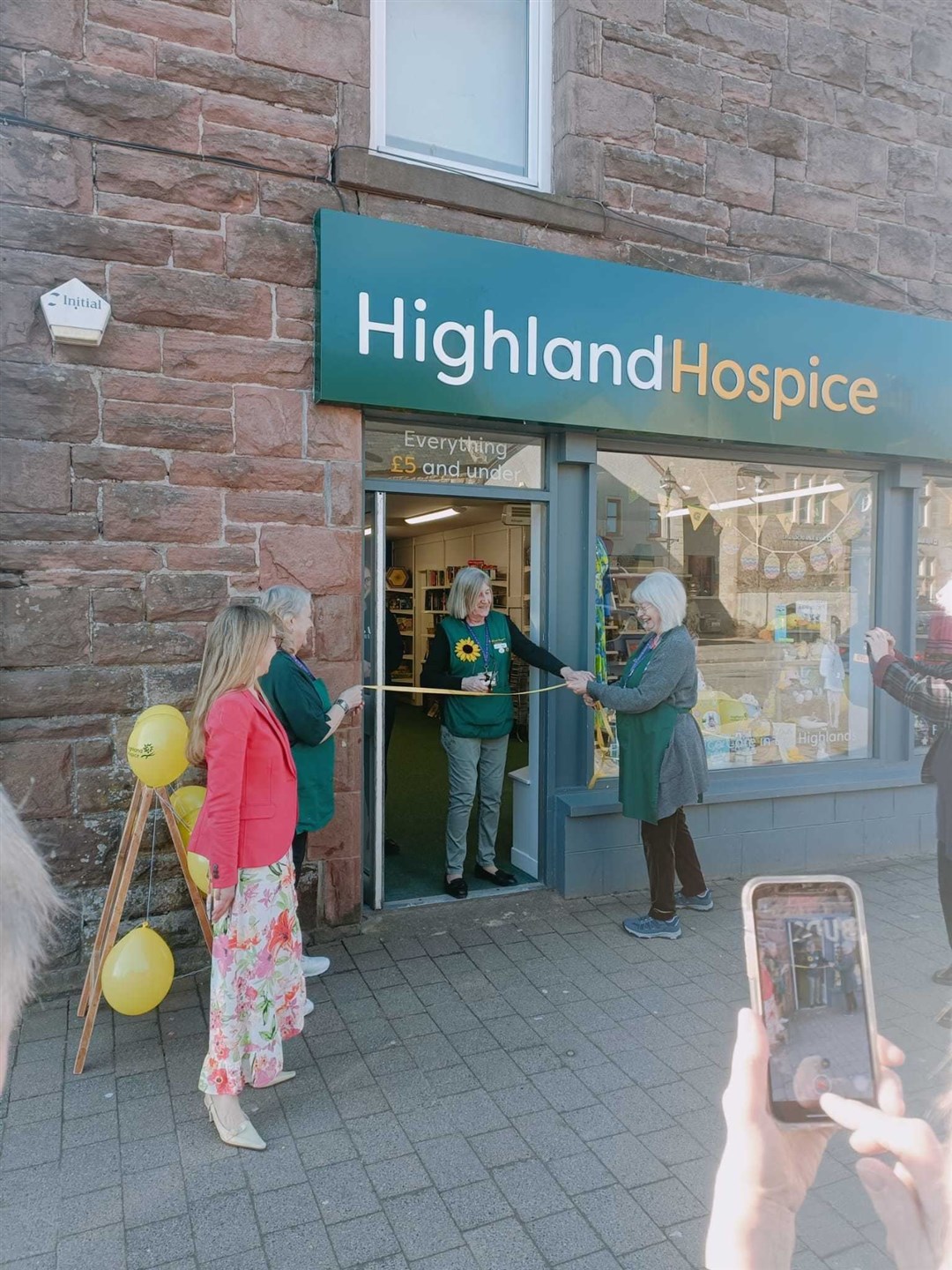 Beryl Sharp cut the ribbon of the new opening at 60 High Street in Alness.