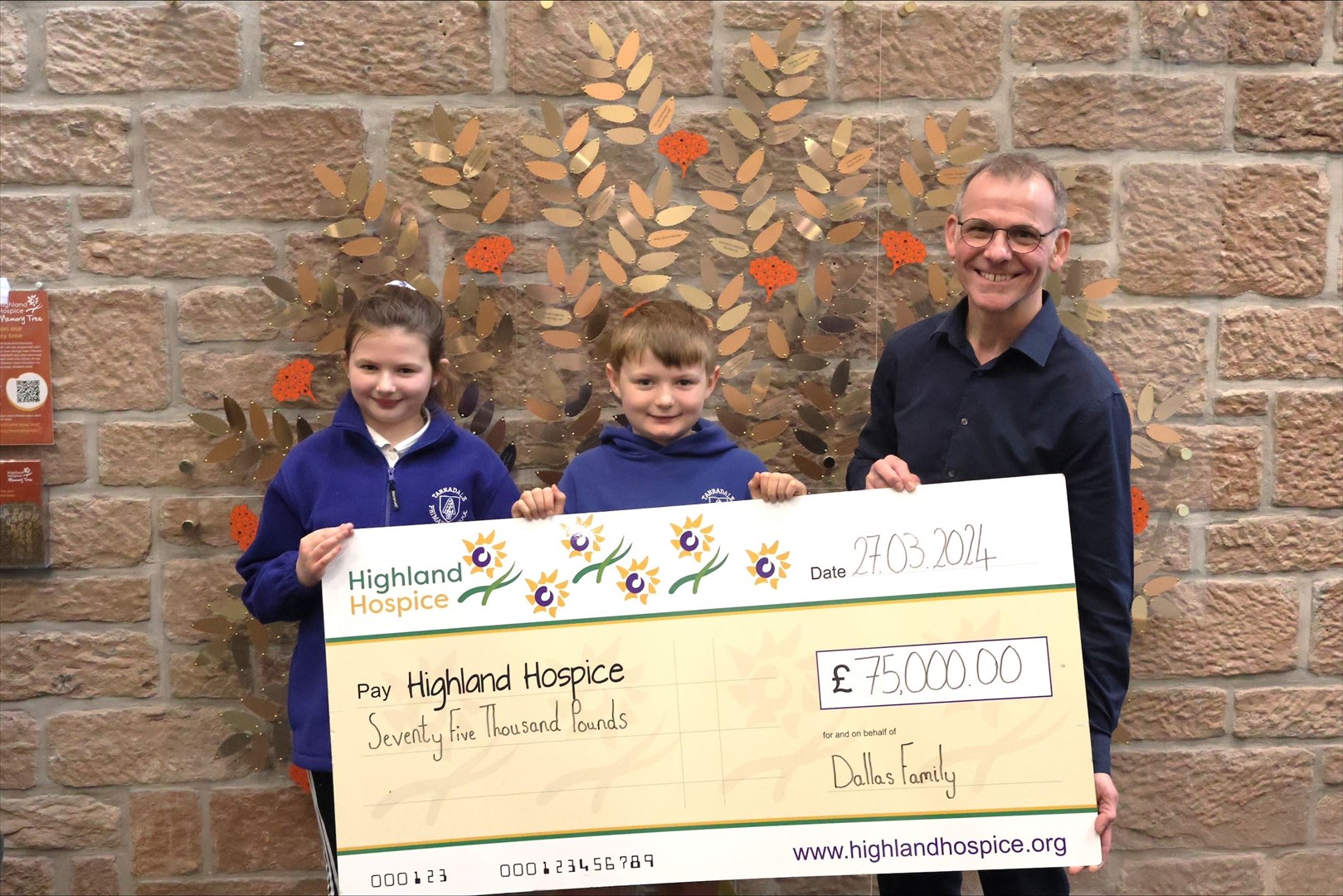 Isla and Murray Dallas, handing the £75,000 donation to Highland Hospice head of income, Andrew Leaver. Picture: Highland Hospice.