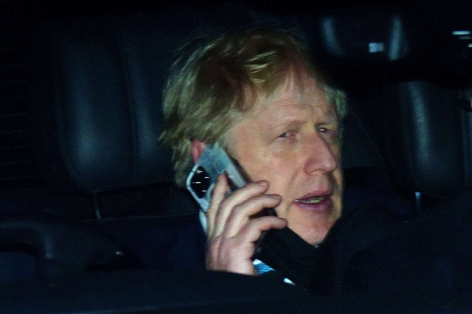 Prime Minister Boris Johnson rides in the back seat of a government car (PA)