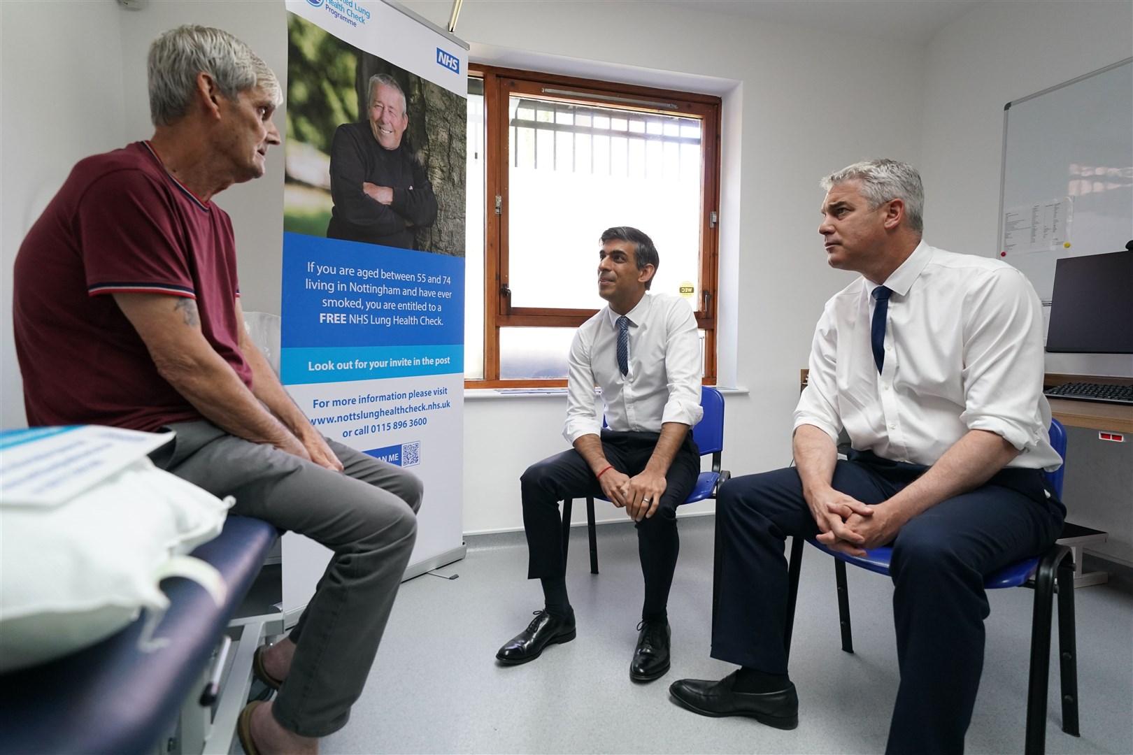 Prime Minister Rishi Sunak with Health Secretary Steve Barclay speaking to patient Terrence during a visit to Rivergreen Medical Centre in Nottingham (Jacob King/PA)