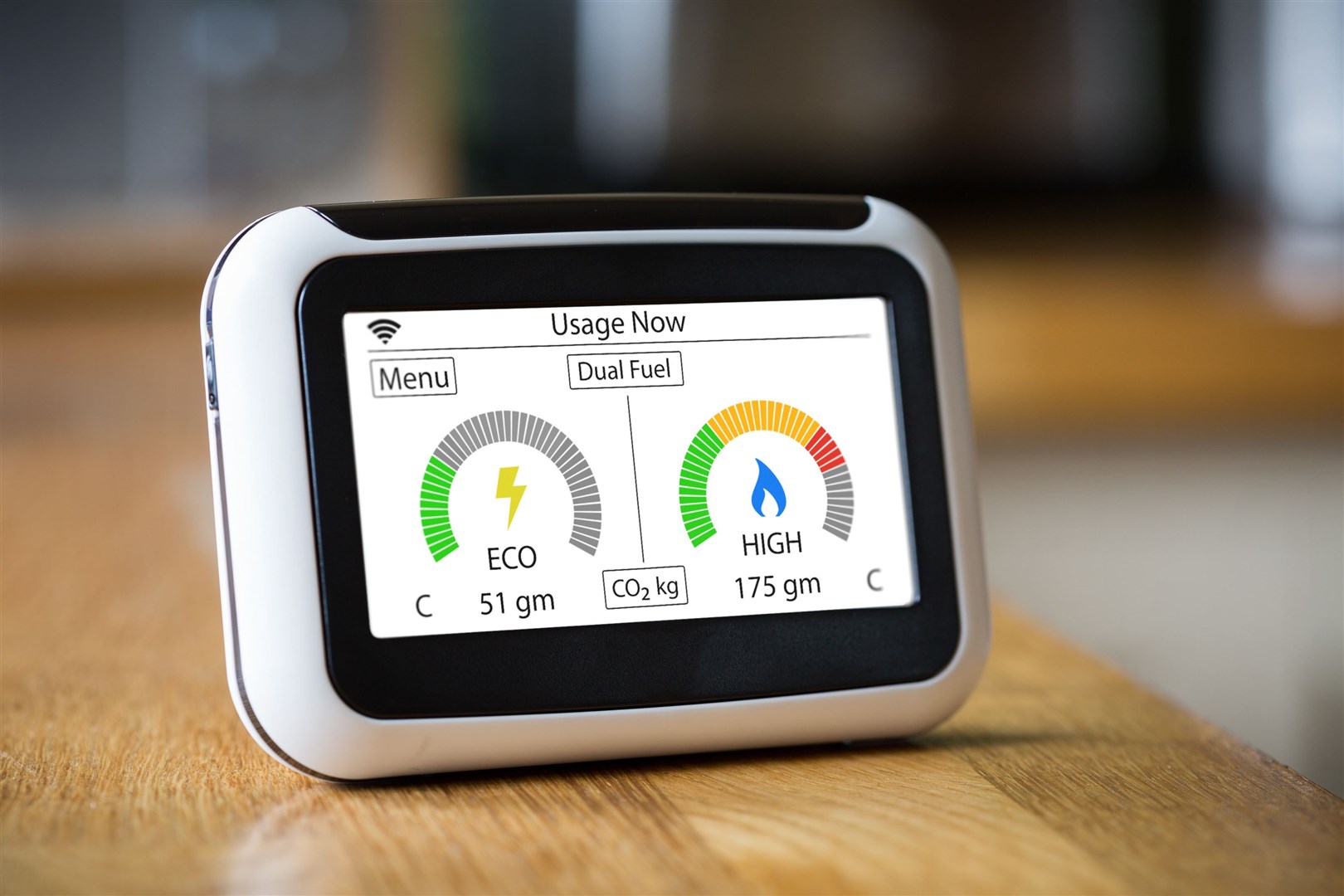 Domestic Energy Smart Meter on a Kitchen Worktop Displaying Electric and Gas Carbon Emissions in Real Time