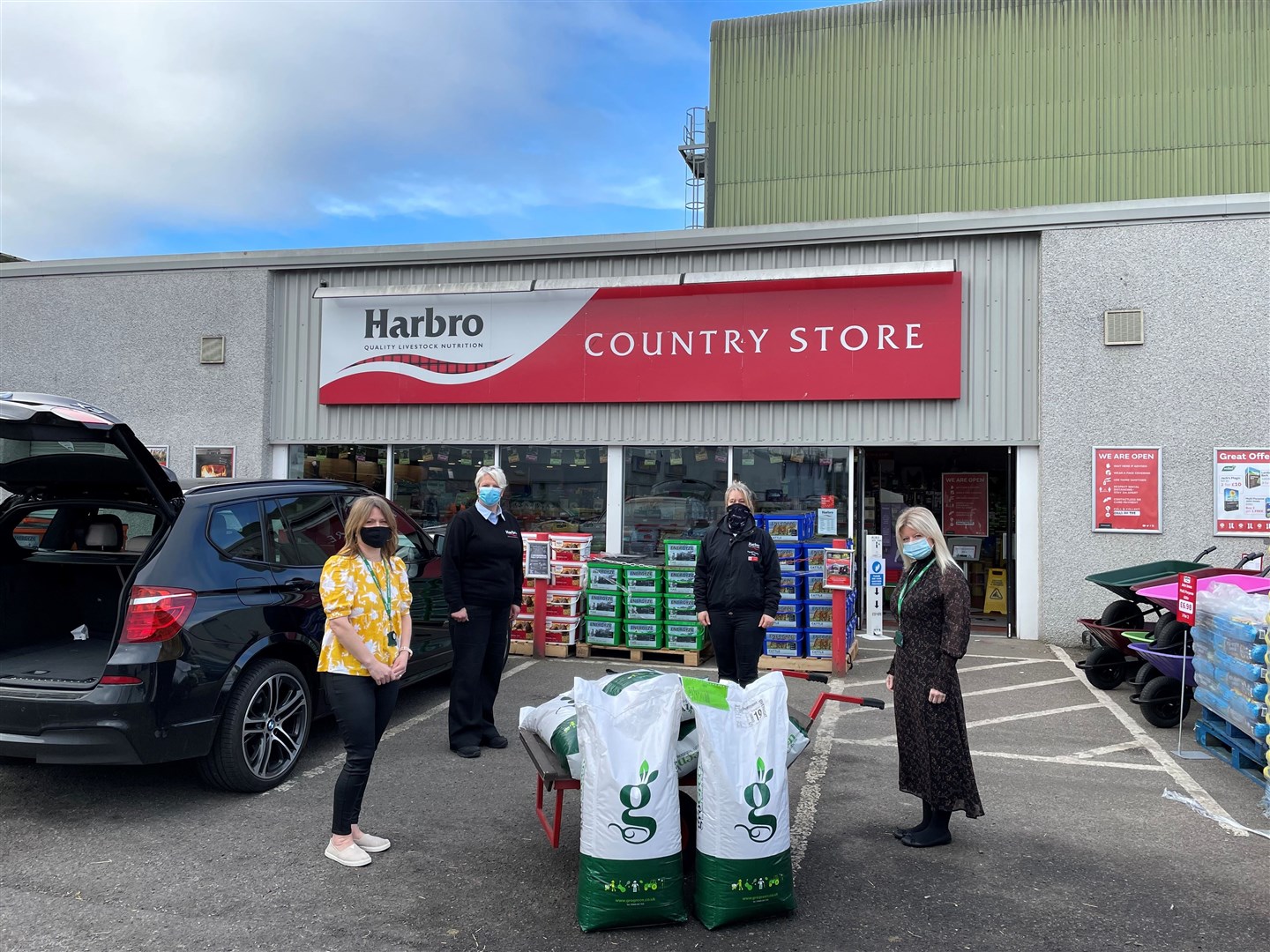 Tracy Sinclair, head teacher and Shona Mitchell, depute head, from Tarradale Primary School, with bags of grass seed, donated by Harbro Country Stores Inverness. They are being handed over by DianeStuart and Sarah Clingan from the store.