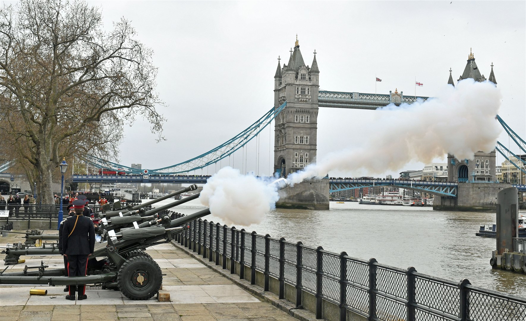 Members of the Honourable Artillery Company begin the 41-round gun salute from the wharf at the Tower of London (Dominic Lipinski/PA)