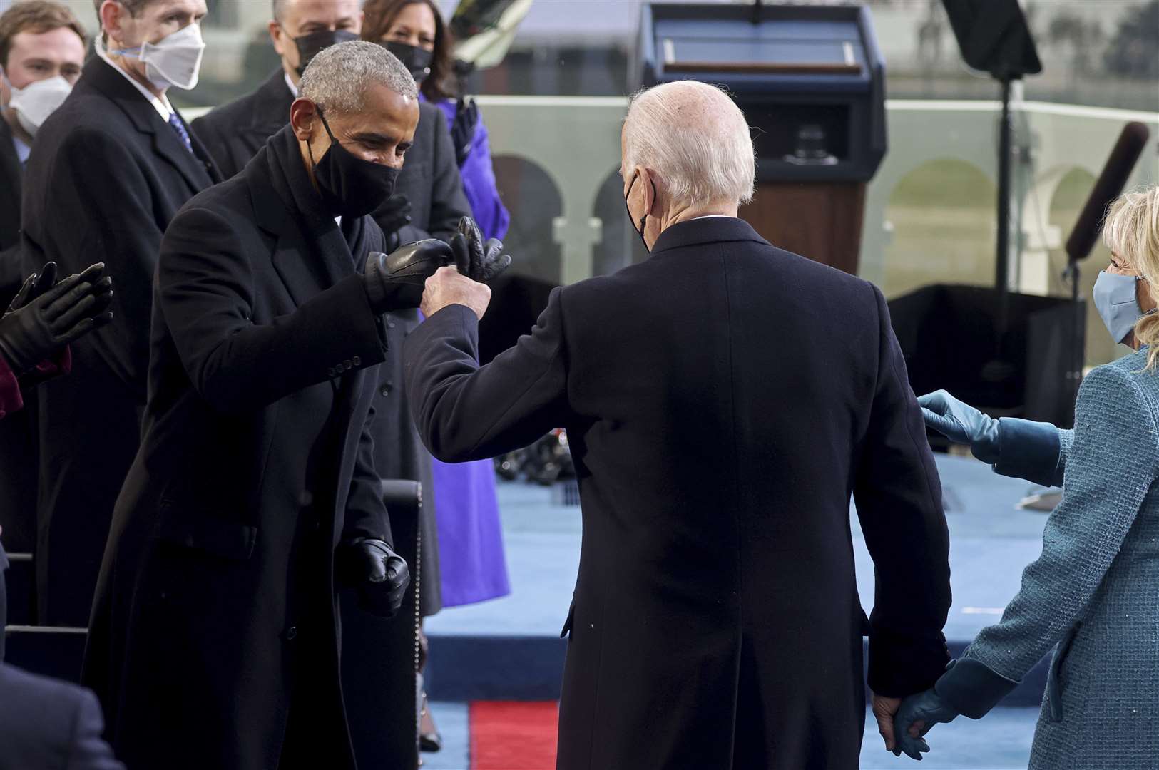 Joe Biden bumps fists with former president Barack Obama during the inauguration (Pool Photo via AP)